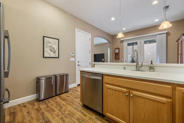 a kitchen with granite countertop white cabinets and stainless steel appliances