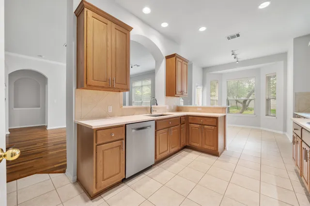 a kitchen with a sink cabinets and window
