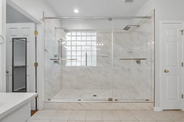 a bathroom with a bathtub and a shower