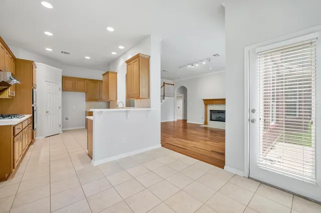 a view of a kitchen with refrigerator and a stove