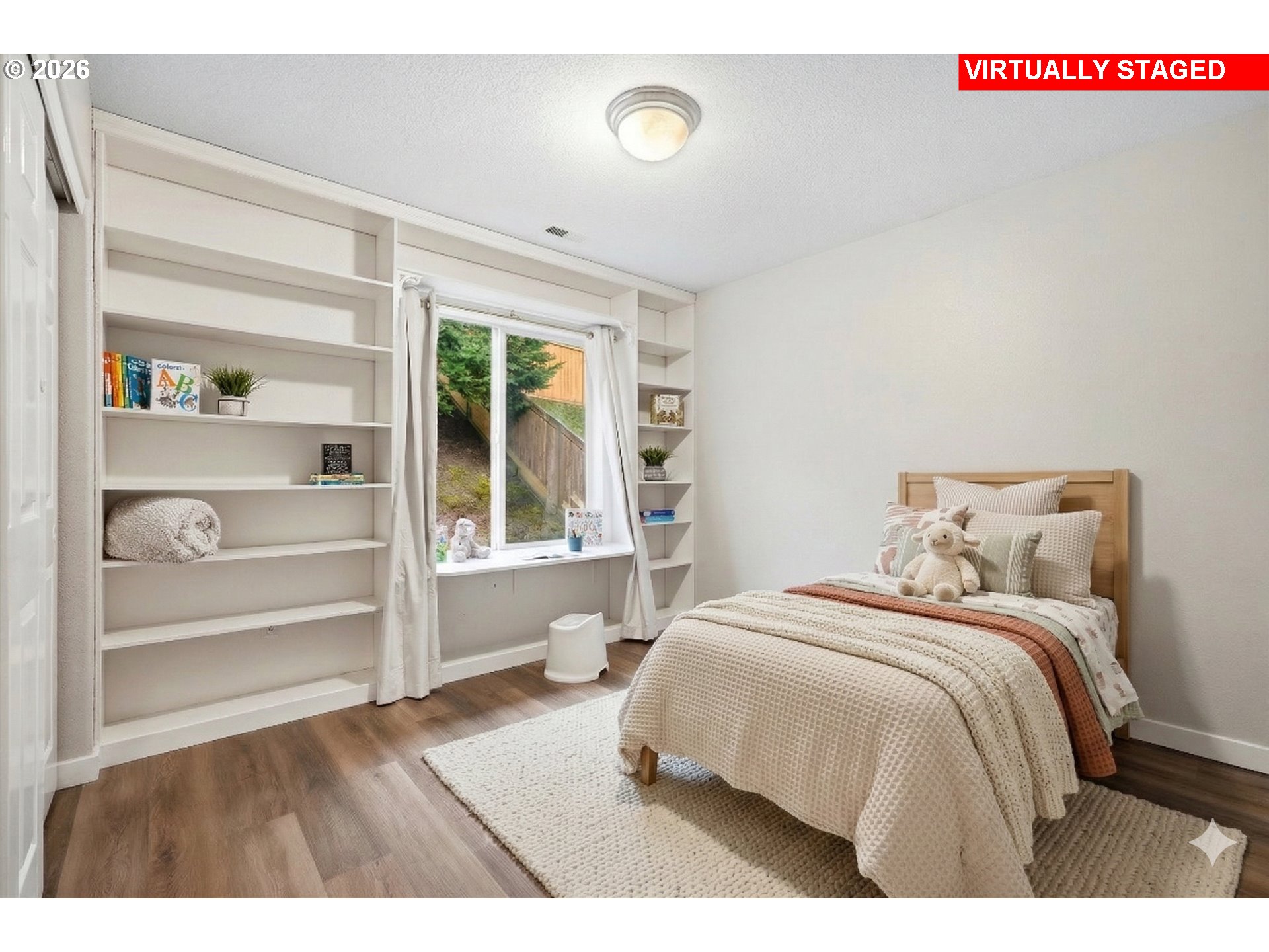 3130 Northwest Pacific Rim Drive Camas, WA 98607 - Photo 17 of 33 a bedroom with a bed and a large window