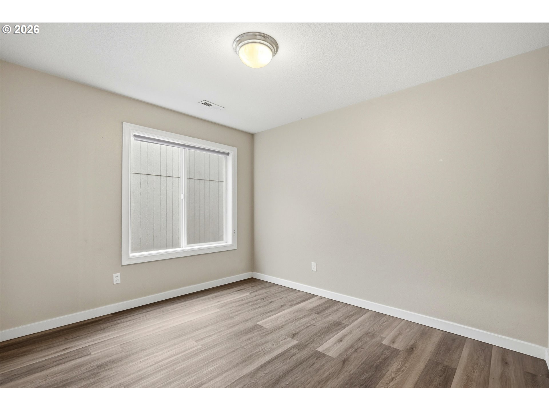 3130 Northwest Pacific Rim Drive Camas, WA 98607 - Photo 19 of 33 a view of an empty room with wooden floor and a window