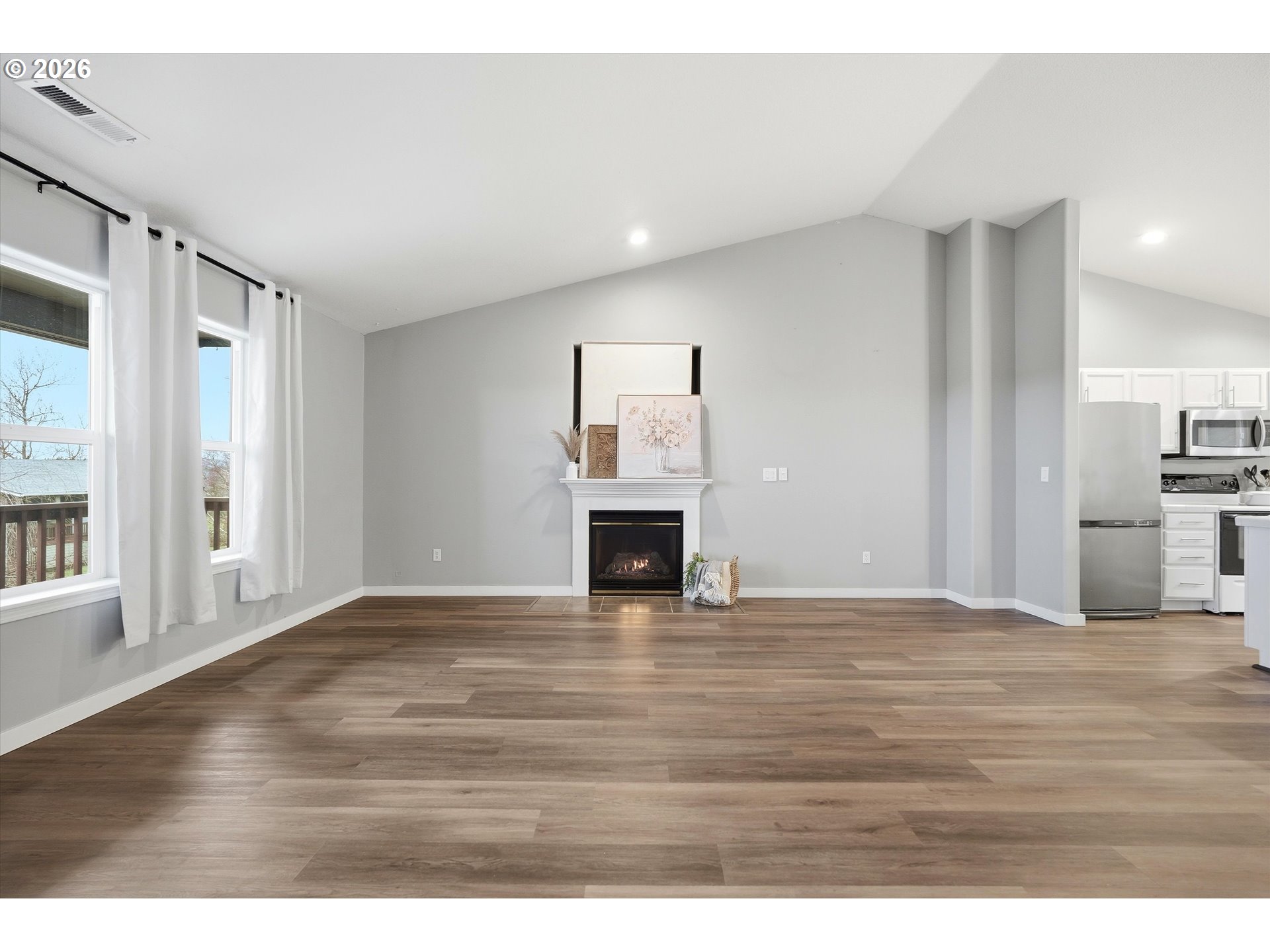 3130 Northwest Pacific Rim Drive Camas, WA 98607 - Photo 4 of 33 a view of empty room with wooden floor and fireplace