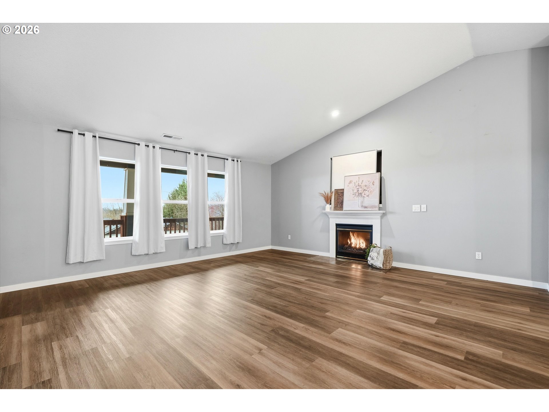 3130 Northwest Pacific Rim Drive Camas, WA 98607 - Photo 7 of 33 a view of an empty room with wooden floor and a window