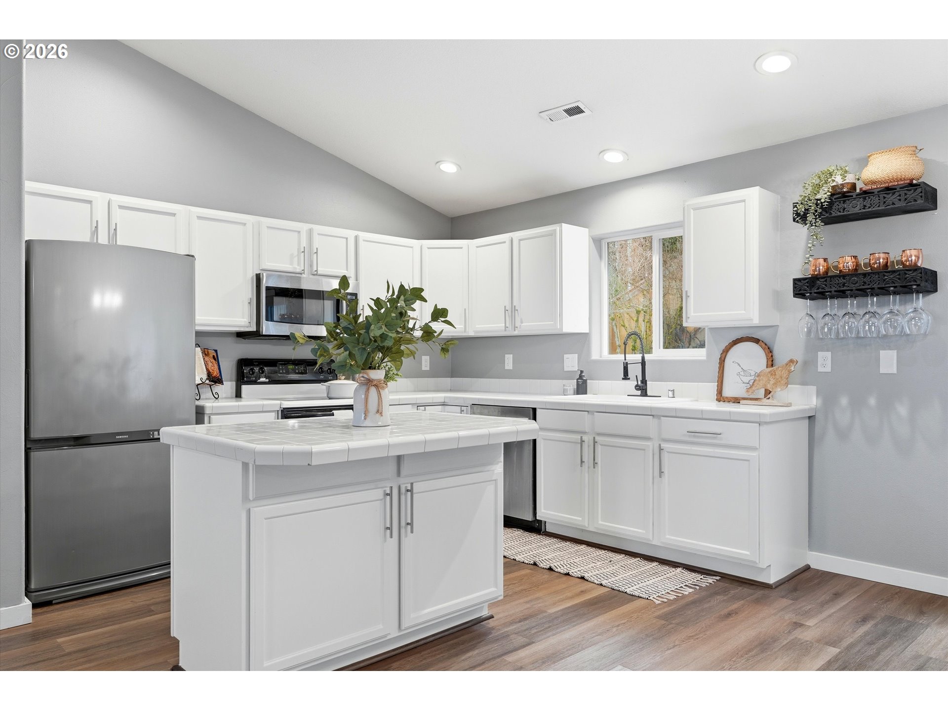 3130 Northwest Pacific Rim Drive Camas, WA 98607 - Photo 9 of 33 a kitchen with kitchen island a sink appliances and cabinets