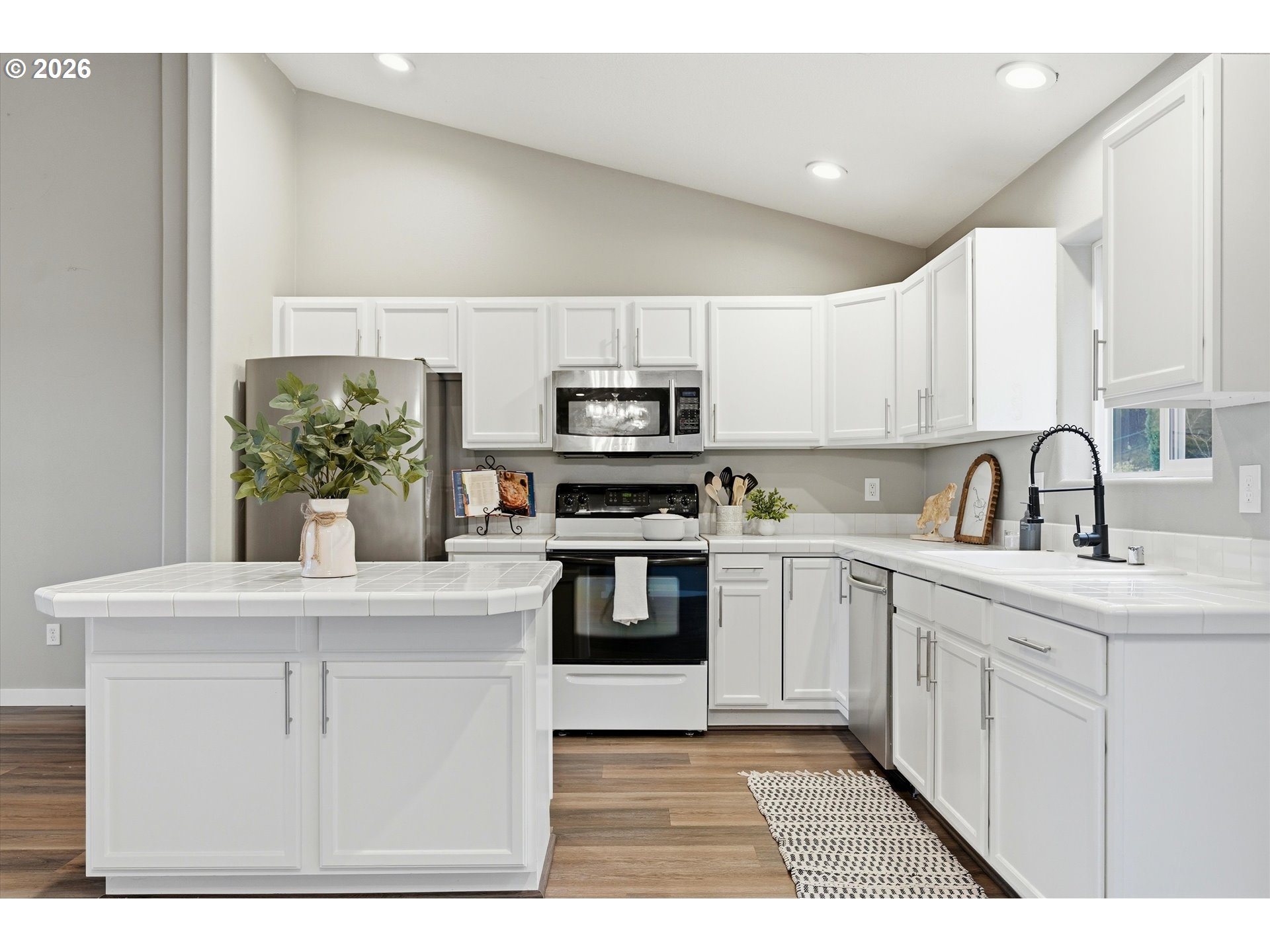 3130 Northwest Pacific Rim Drive Camas, WA 98607 - Photo 10 of 33 a kitchen with stainless steel appliances granite countertop a stove and a sink