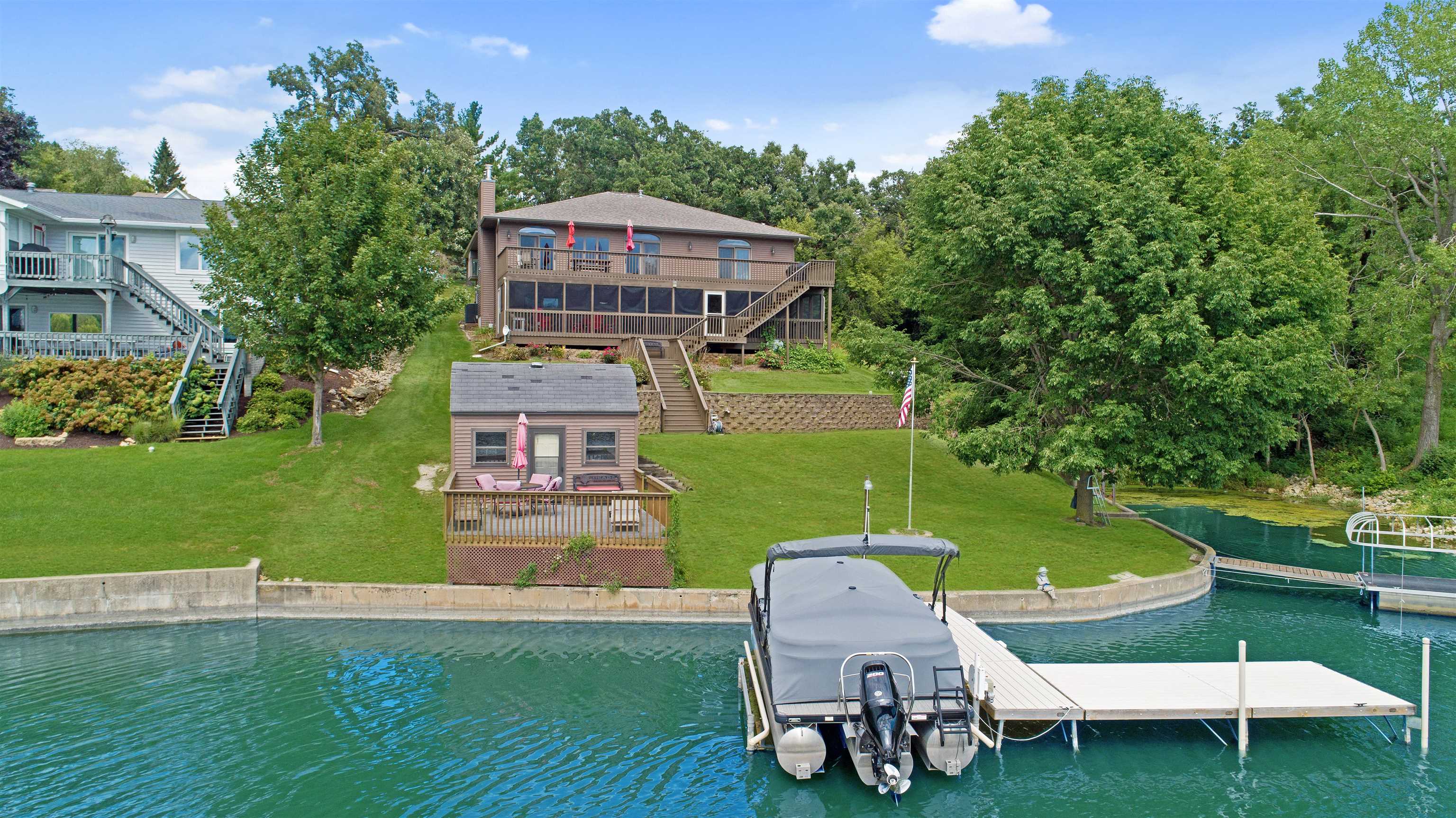 an aerial view of a house with swimming pool garden and trees