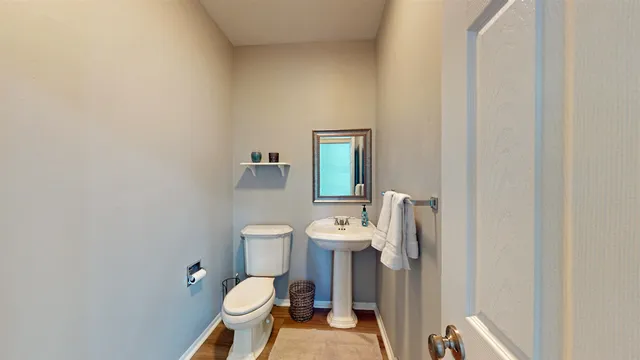 a white toilet sitting next to a bathroom sink