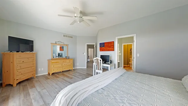 a bedroom with a bed and wooden floor