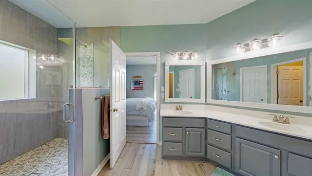 a spacious bathroom with a shower sink and mirror