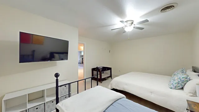 a bedroom with a bed and a chandelier