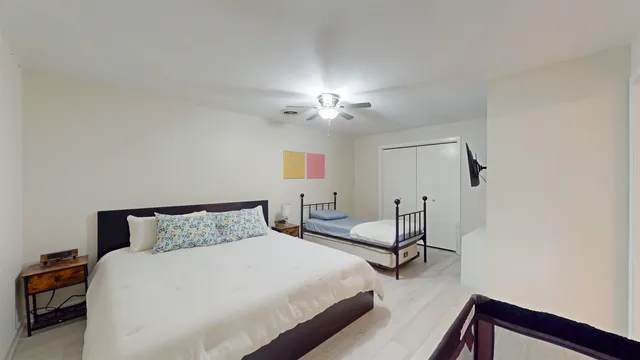 a bedroom with a bed and a chandelier