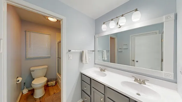 a bathroom with a toilet sink and mirror