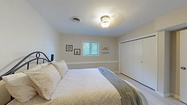 a bedroom with a bed and a window
