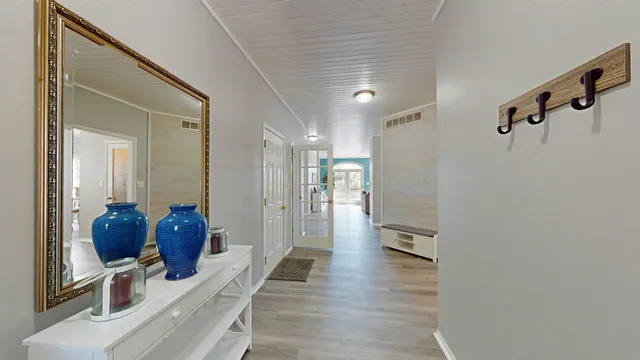 a hallway with furniture and wooden floor