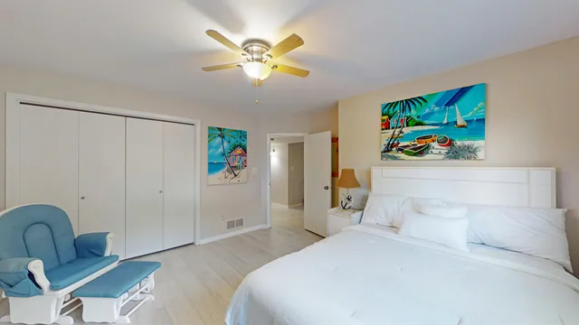 a bedroom with a bed and a chandelier