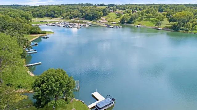 an aerial view of a residential house with outdoor space and swimming pool