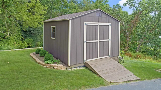 a view of a house with a yard and tree s