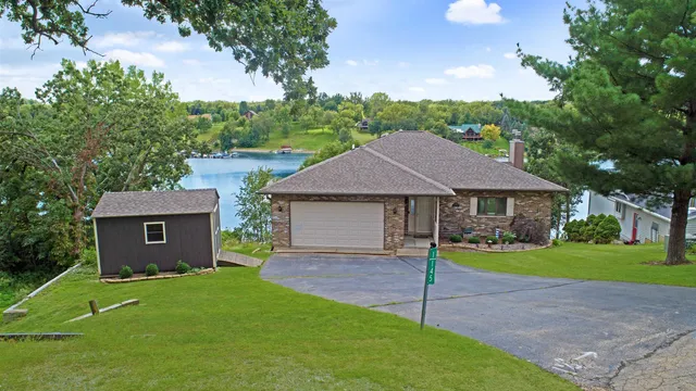 a view of house with a yard and deck