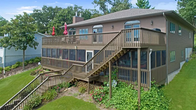 an aerial view of a house with swimming pool and deck