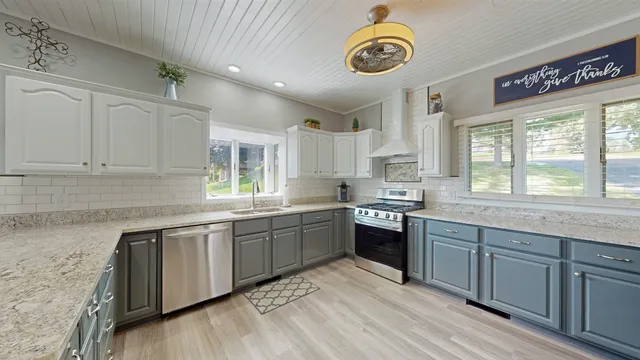 a kitchen with a sink cabinets and window
