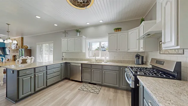 a kitchen with a sink stove and cabinets