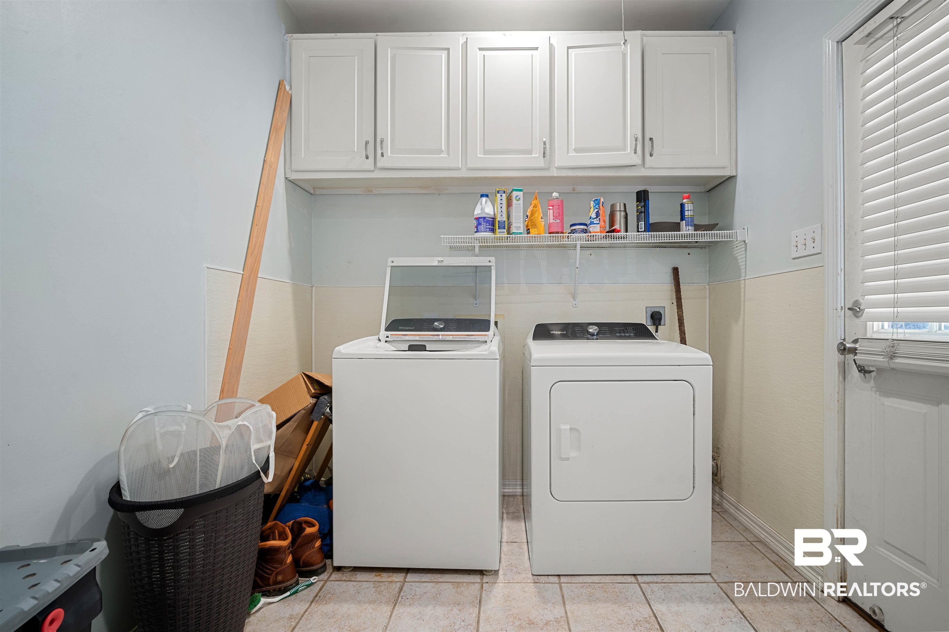 1609 Repoll Road Mobile, AL 36695 - Photo 19 of 22 Laundry room with light tile patterned floors, washer and clothes dryer, and cabinet space