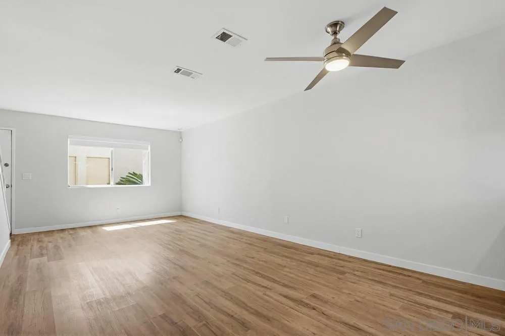 5130 North River Road, Unit B Oceanside, CA 92057 - Photo 27 of 51 an empty room with wooden floor ceiling fan and window
