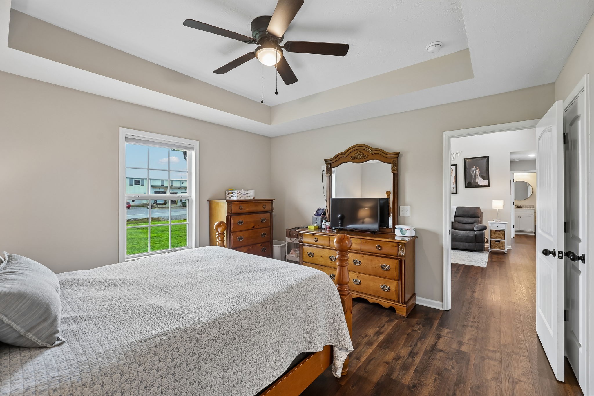 1715 Old Belfast Road Lewisburg, TN 37091 - Photo 26 of 42 a bedroom with a large bed and a chandelier