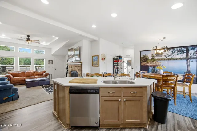 a kitchen that has a lot of cabinets a sink and appliances
