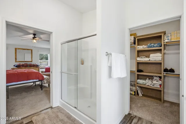 a bathroom with a double vanity sink a large mirror and a bathtub