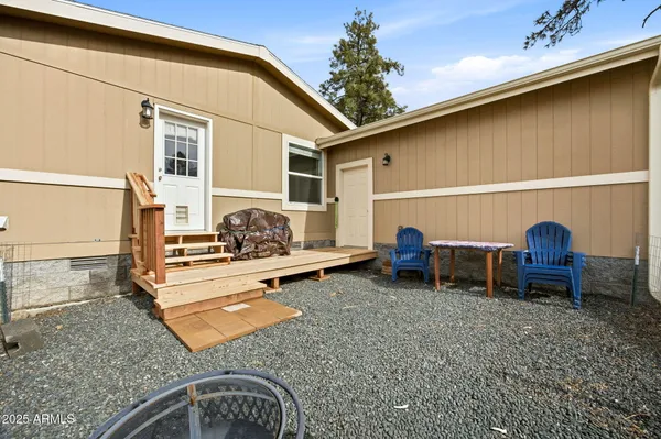 a backyard of a house with table and chairs