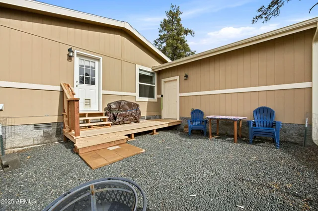 a backyard of a house with table and chairs