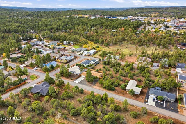 an aerial view of a house with a yard basket ball court