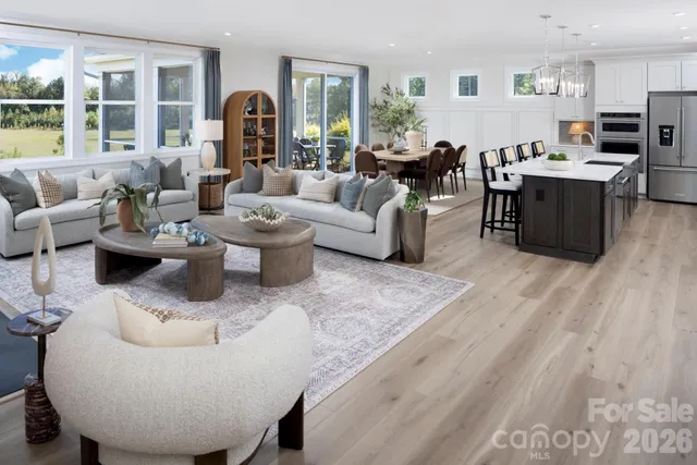 a living room with furniture and a book shelf