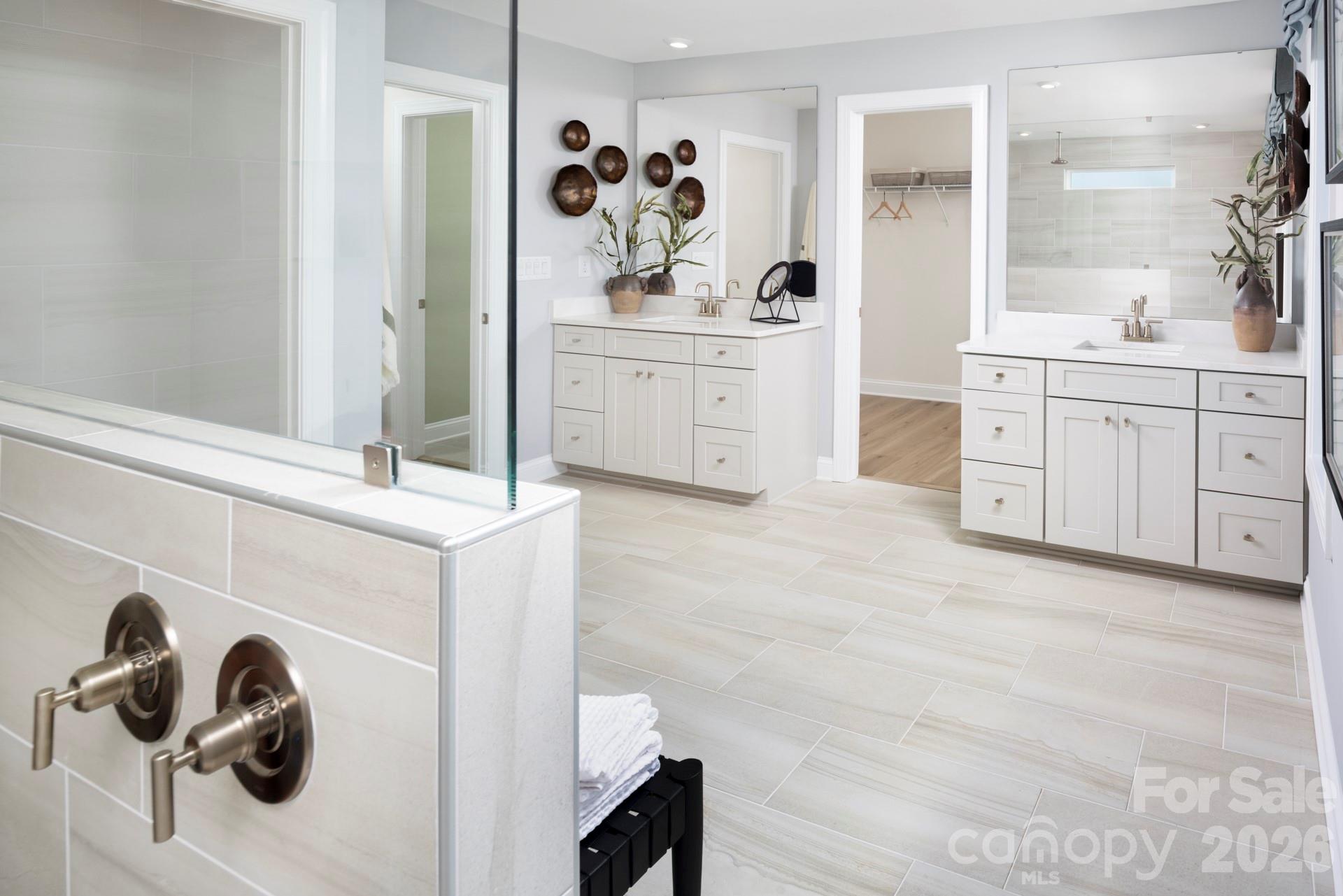 2532 Mabel Lane Monroe, NC 28110 - Photo 34 of 35 a spacious bathroom with a double vanity sink and mirror