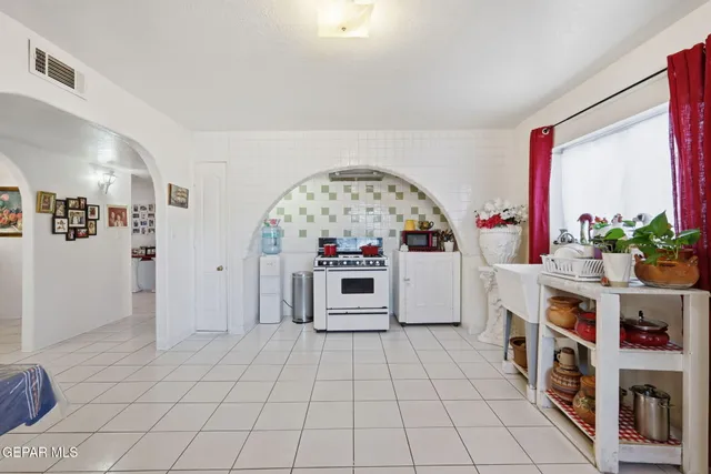 a living room with furniture and flowers
