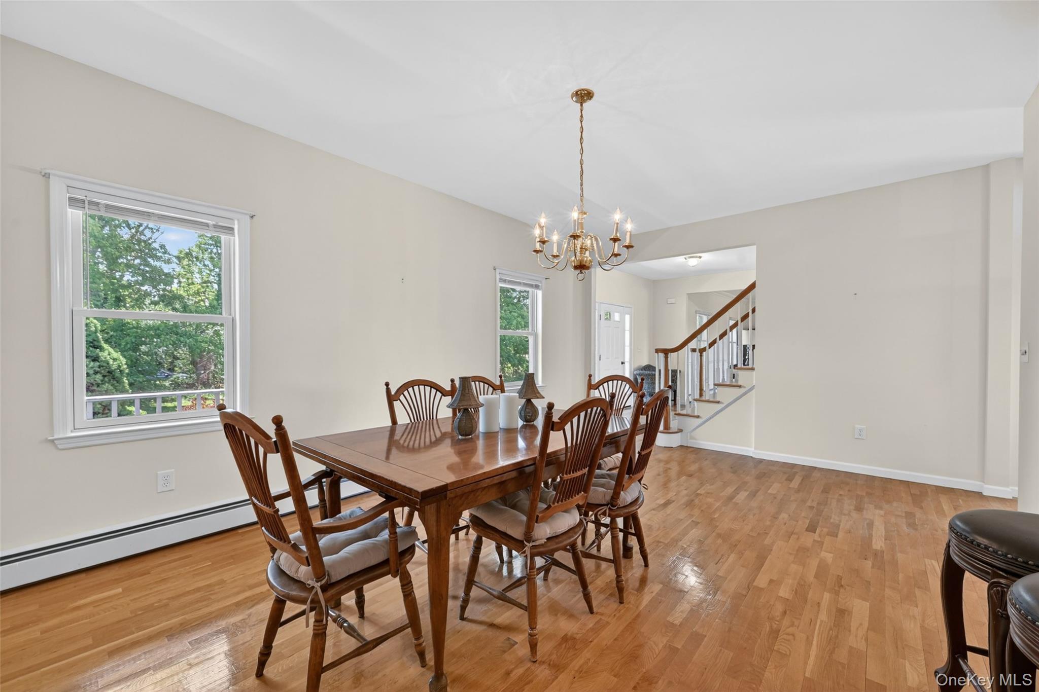 19 Bull Mine Road Chester, NY 10918 - Photo 10 of 42 Spacious dining area featuring wood-finish flooring, two windows, and a brass chandelier