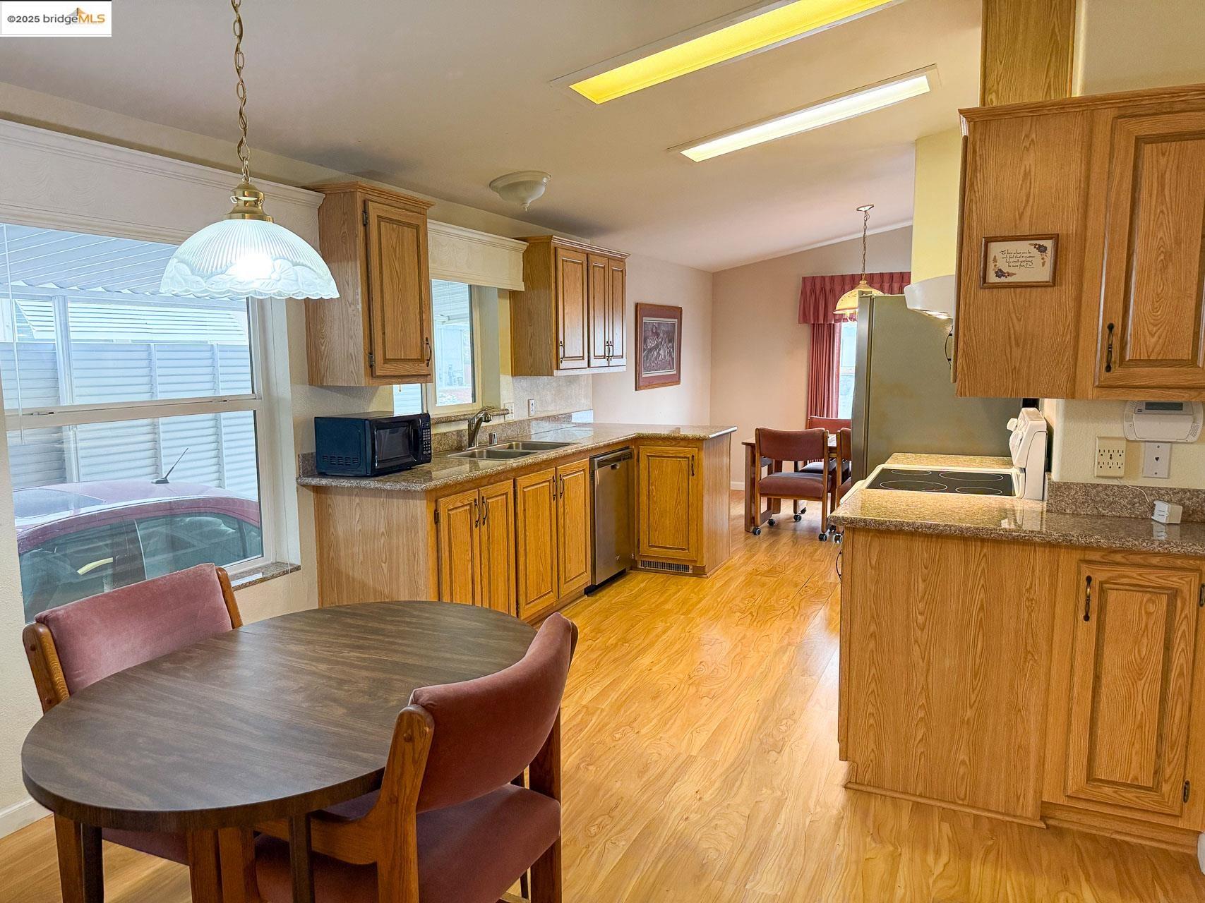 18717 Mill Villa Road, Unit 636 Jamestown, CA 95327 - Photo 11 of 24 a large kitchen with kitchen island a dining table and chairs