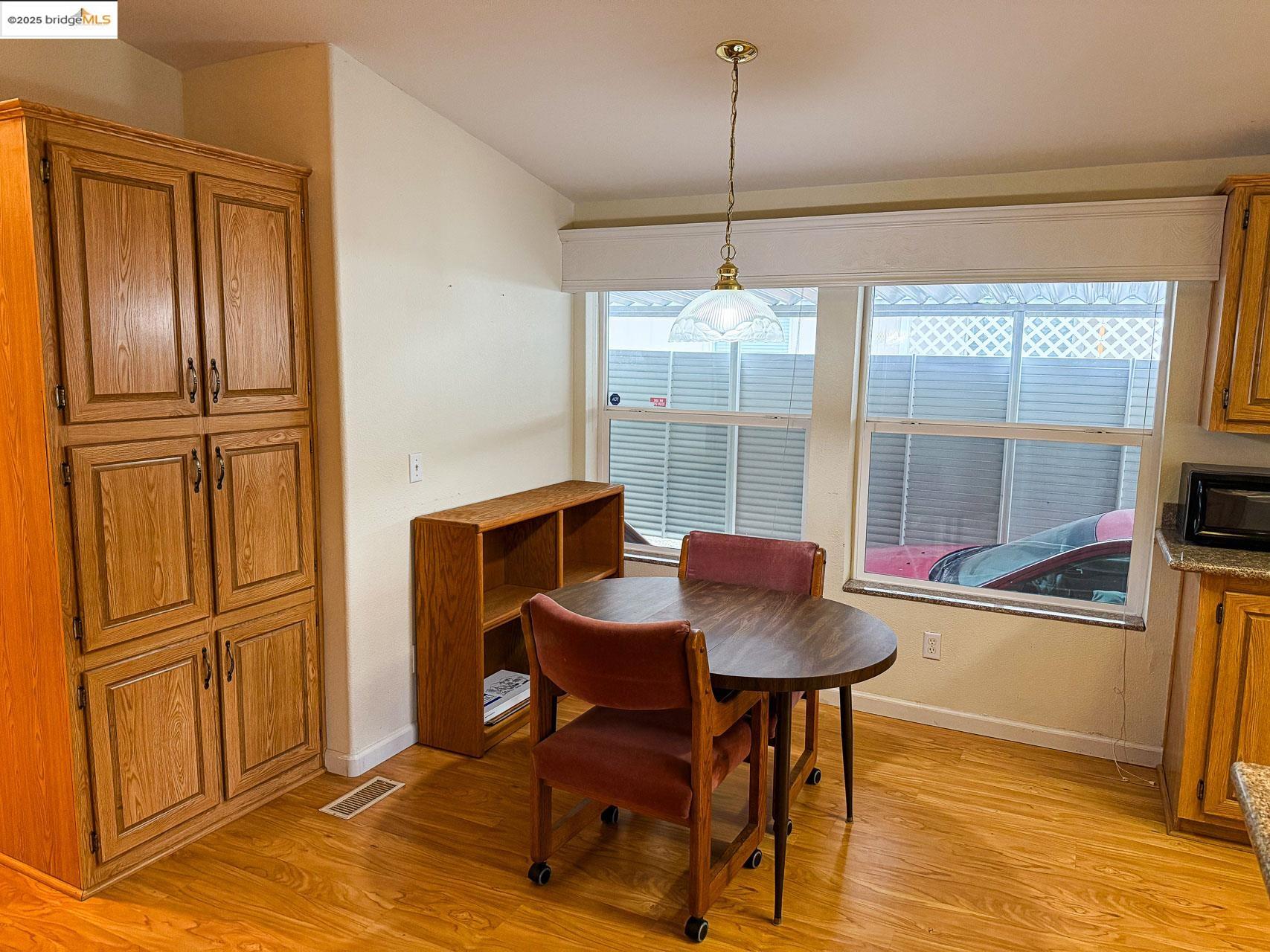 18717 Mill Villa Road, Unit 636 Jamestown, CA 95327 - Photo 14 of 24 a view of a dining room with furniture window and wooden floor
