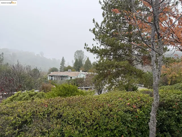 a view of a house with wooden fence