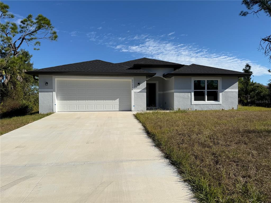 2164 Northland Avenue North Port, FL 34288 - Photo 1 of 31 a front view of a house with a yard and garage