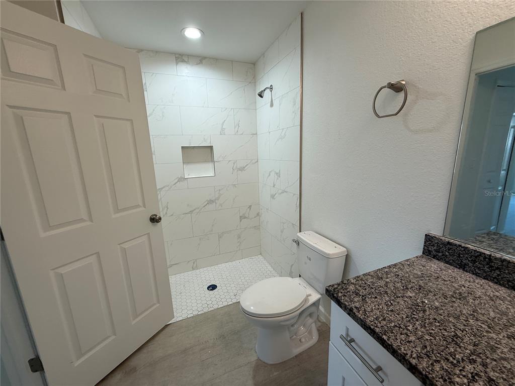 2164 Northland Avenue North Port, FL 34288 - Photo 11 of 31 a bathroom with a granite countertop sink toilet and shower