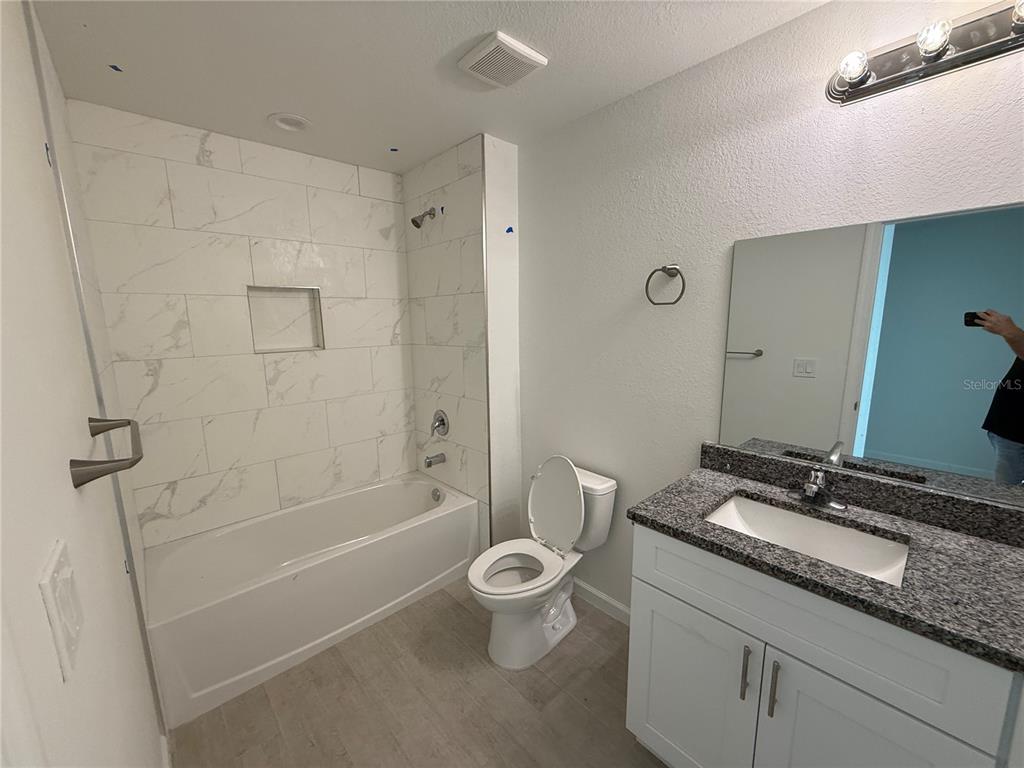 2164 Northland Avenue North Port, FL 34288 - Photo 14 of 31 a bathroom with a granite countertop sink a toilet and shower