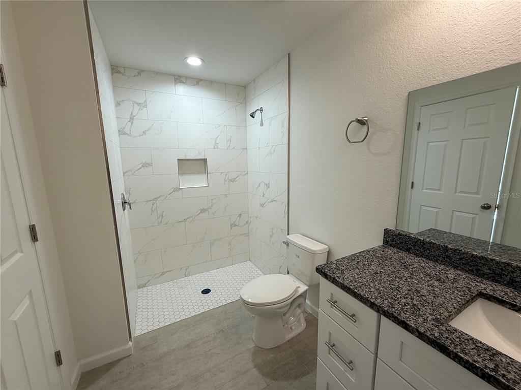 2164 Northland Avenue North Port, FL 34288 - Photo 15 of 31 a bathroom with a granite countertop sink a toilet and shower