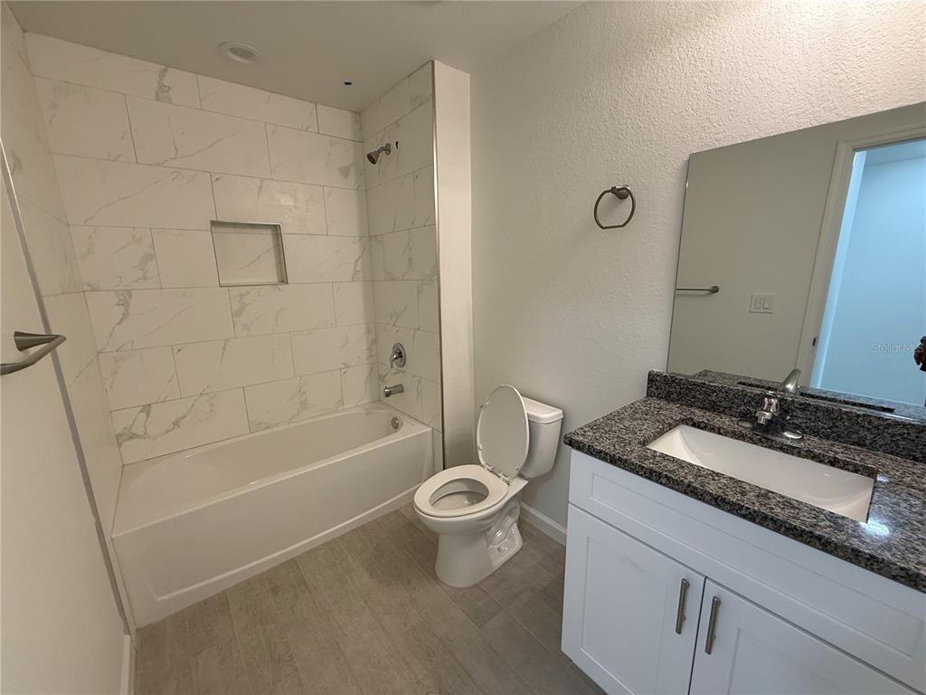 2164 Northland Avenue North Port, FL 34288 - Photo 20 of 31 a bathroom with a granite countertop sink a toilet and shower