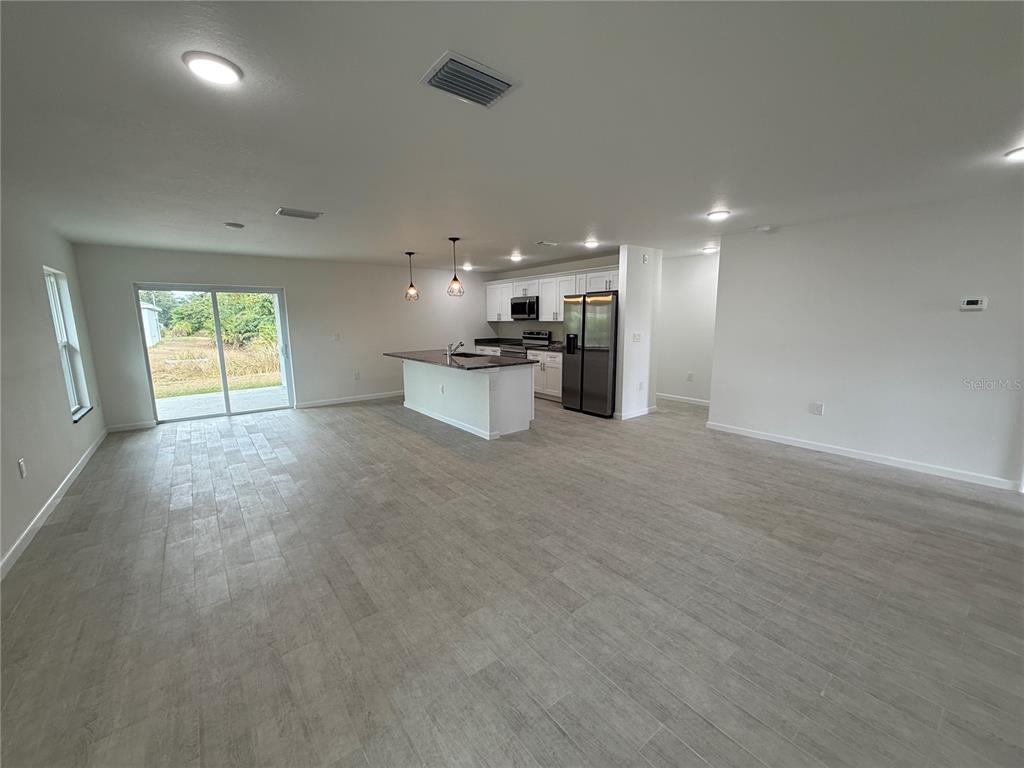 2164 Northland Avenue North Port, FL 34288 - Photo 8 of 31 an empty room with windows and kitchen view