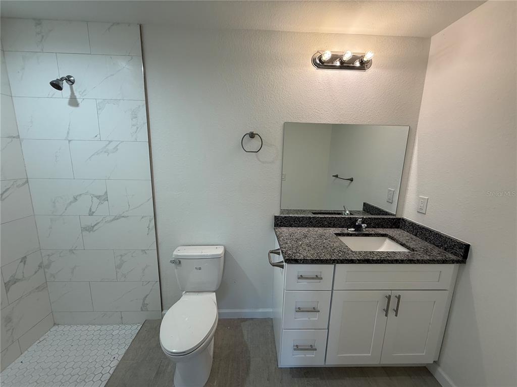 2164 Northland Avenue North Port, FL 34288 - Photo 10 of 31 a bathroom with a granite countertop toilet sink and mirror