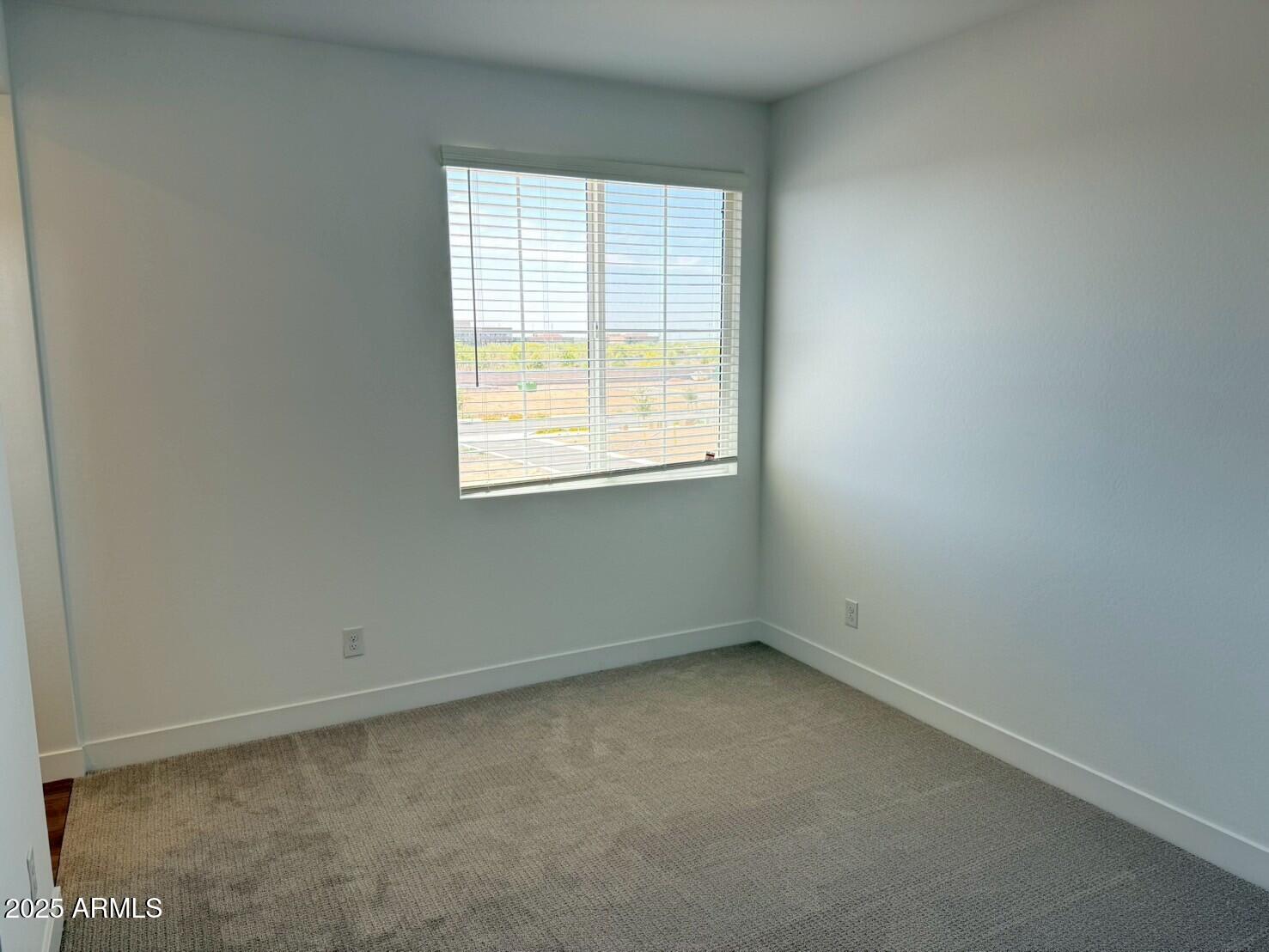 2443 West Rowel Road Phoenix, AZ 85085 - Photo 10 of 19 an empty room with a window