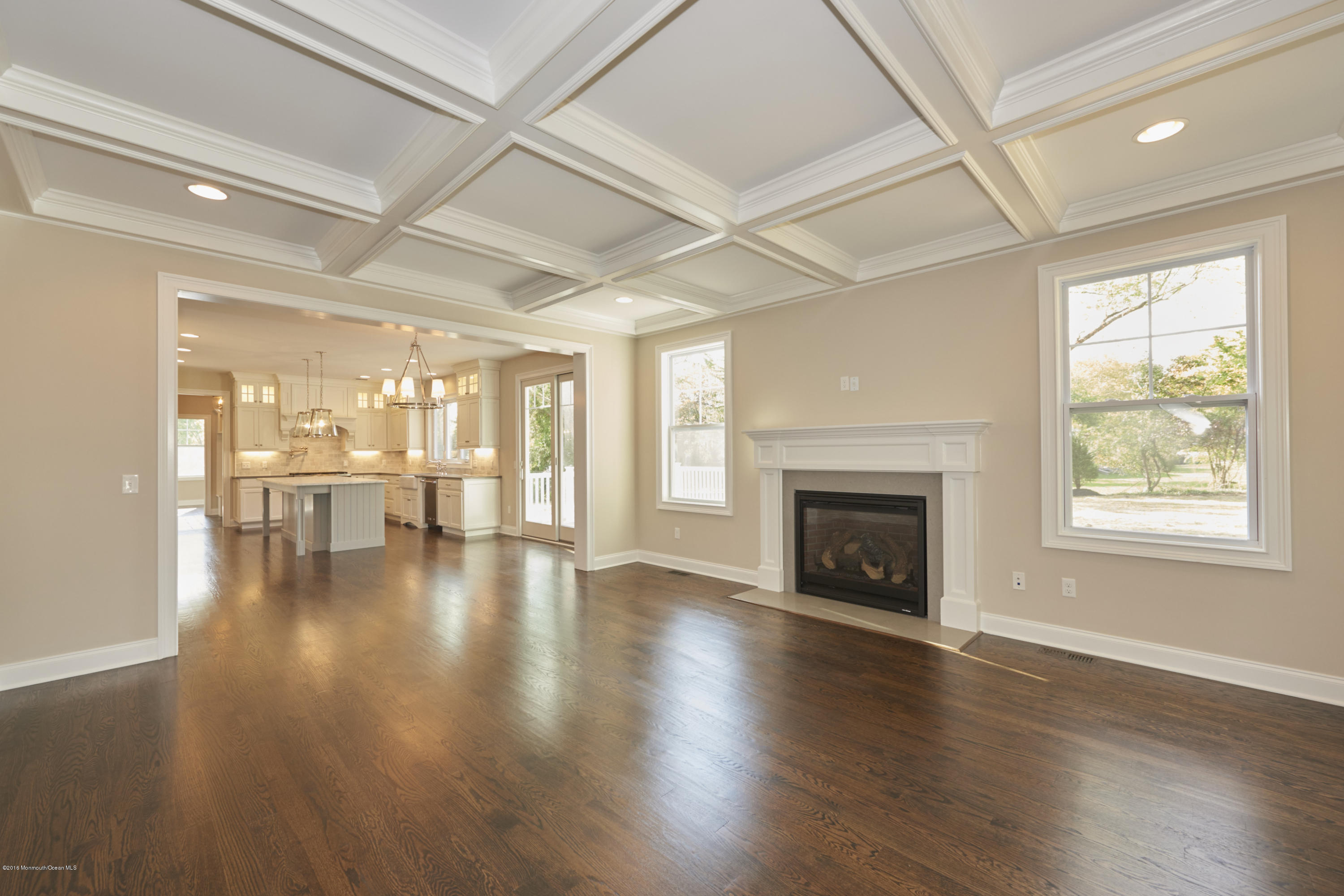 17 Cardinal Road Middletown, NJ 07748 - Photo 11 of 22 an empty room with wooden floor fireplace and windows